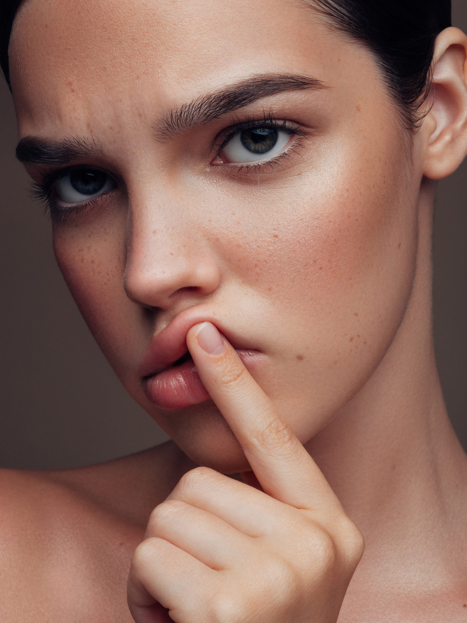 Woman pushing on her lip with pointer finger
