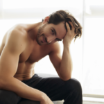 Shirtless White Man With Beautiful Hair is smiling and looking