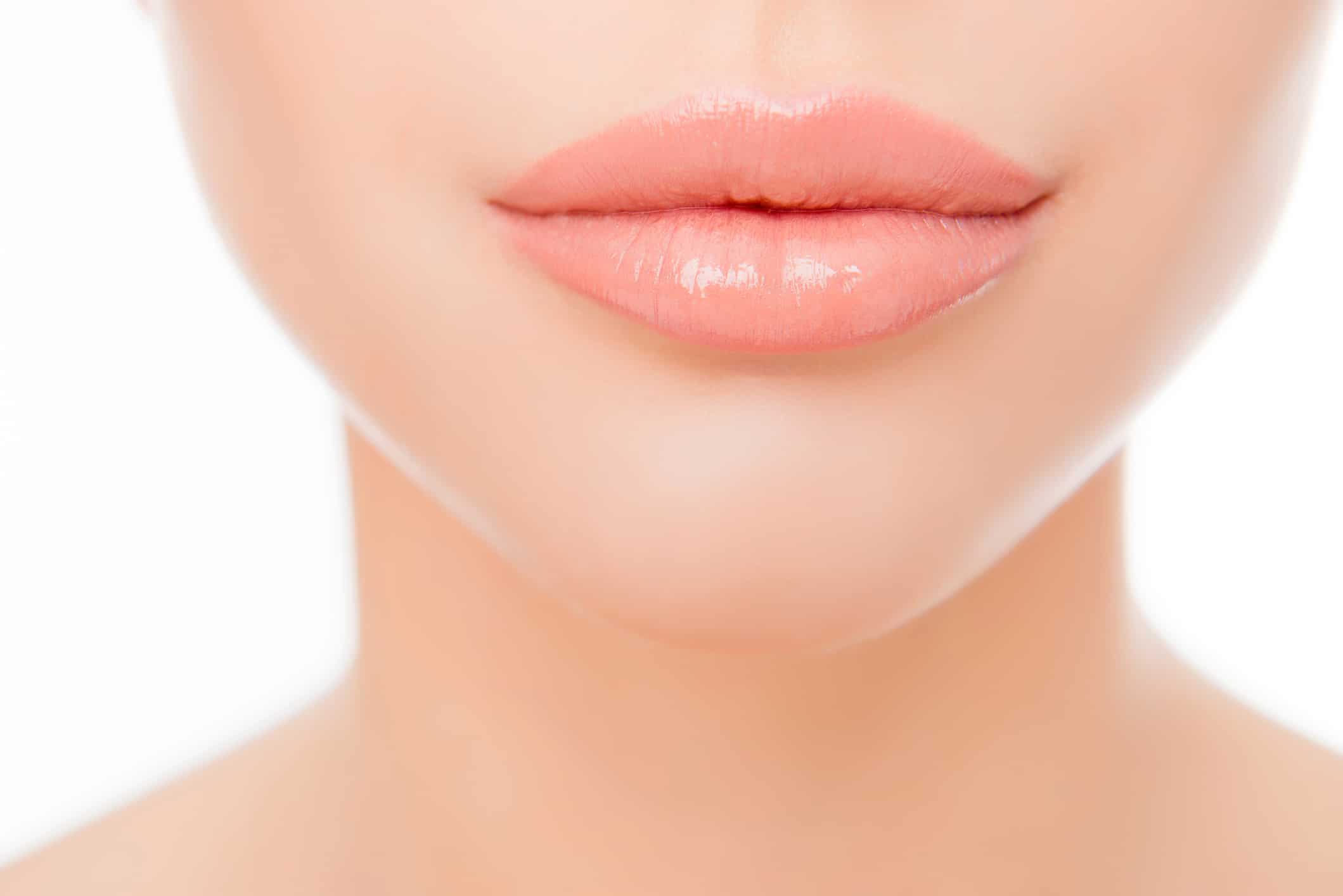 Close up photo of full woman's lips after augmentation
